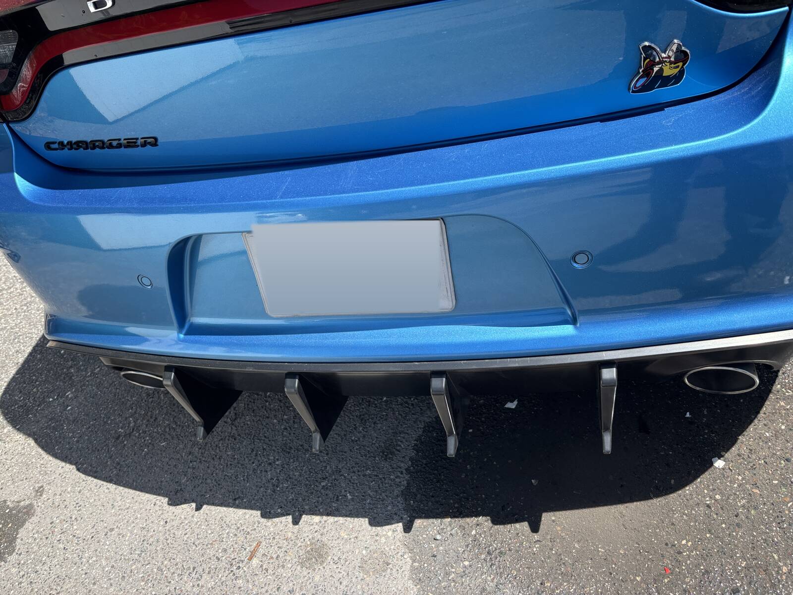 The back of a blue Dodge Charger, repainted and put back together.