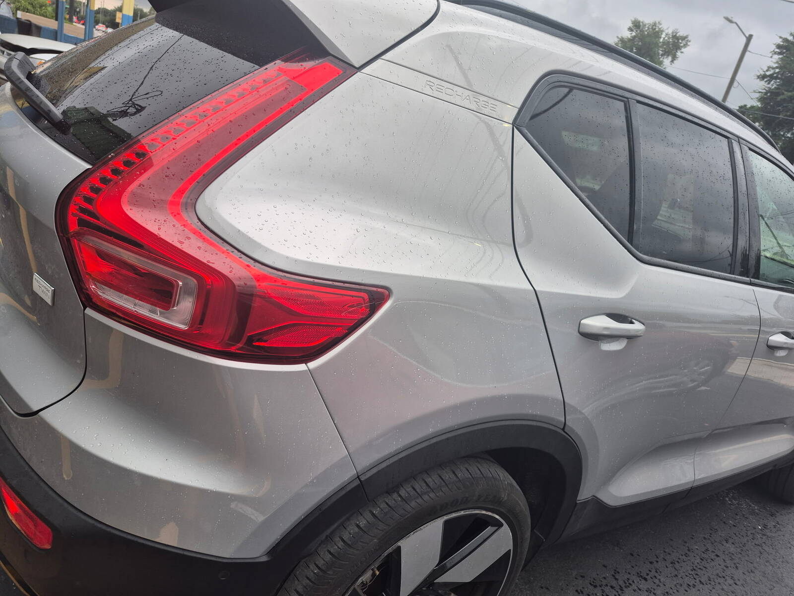 A silver Volvo SUV after body and paint work, clean and glossy from the back.